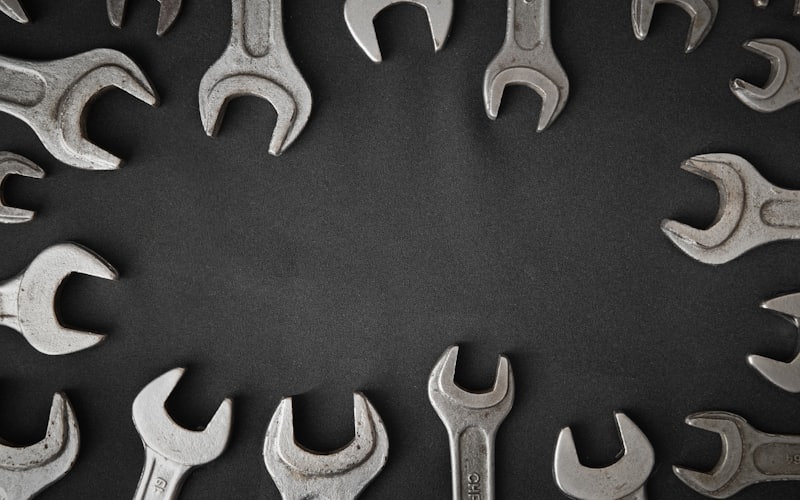 Set of professional spanners laid out on a dark work surface