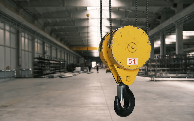 Five tonne crane hook block hanging inside an industrial warehouse