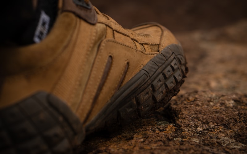 Close view of a rugged work boot with a reinforced toe and deep tread