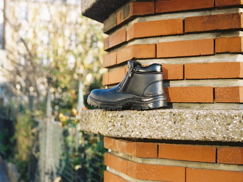 Black leather safety boot with a reinforced toe and slip resistant sole