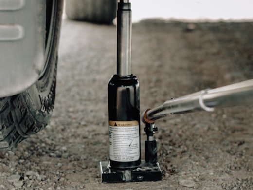 Hydraulic bottle jack lifting a vehicle